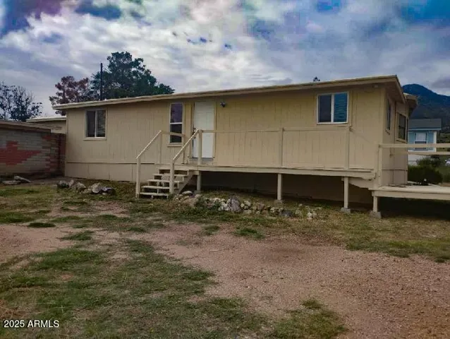 a backyard of a house with wooden fence