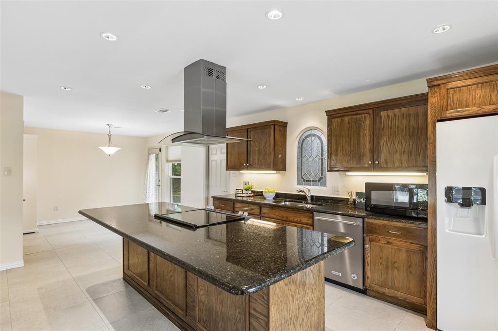 1548 Timbercreek Drive Howe, TX 75459 - Photo 7 of 24 a kitchen with granite countertop a sink and cabinets