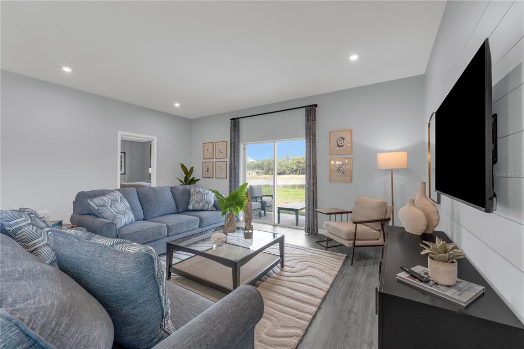 933 Pearlwood Loop Bartow, FL 33830 - Photo 16 of 39 a living room with furniture a flat screen tv and a large window