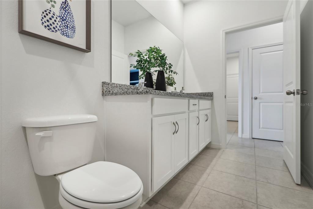 933 Pearlwood Loop Bartow, FL 33830 - Photo 33 of 39 a bathroom with a toilet sink and mirror