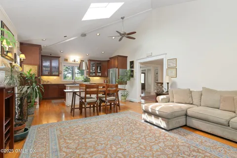 a living room with furniture and kitchen view