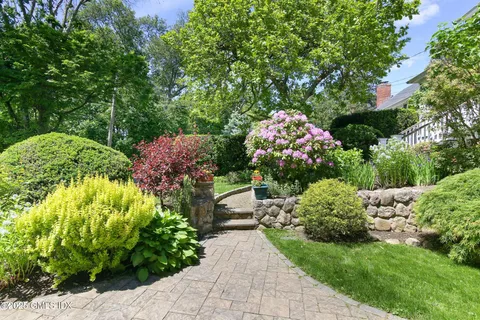 an aerial view of a house with outdoor space and street view