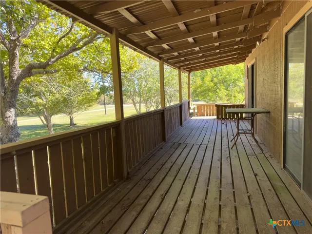 a view of an empty room with floor to ceiling window