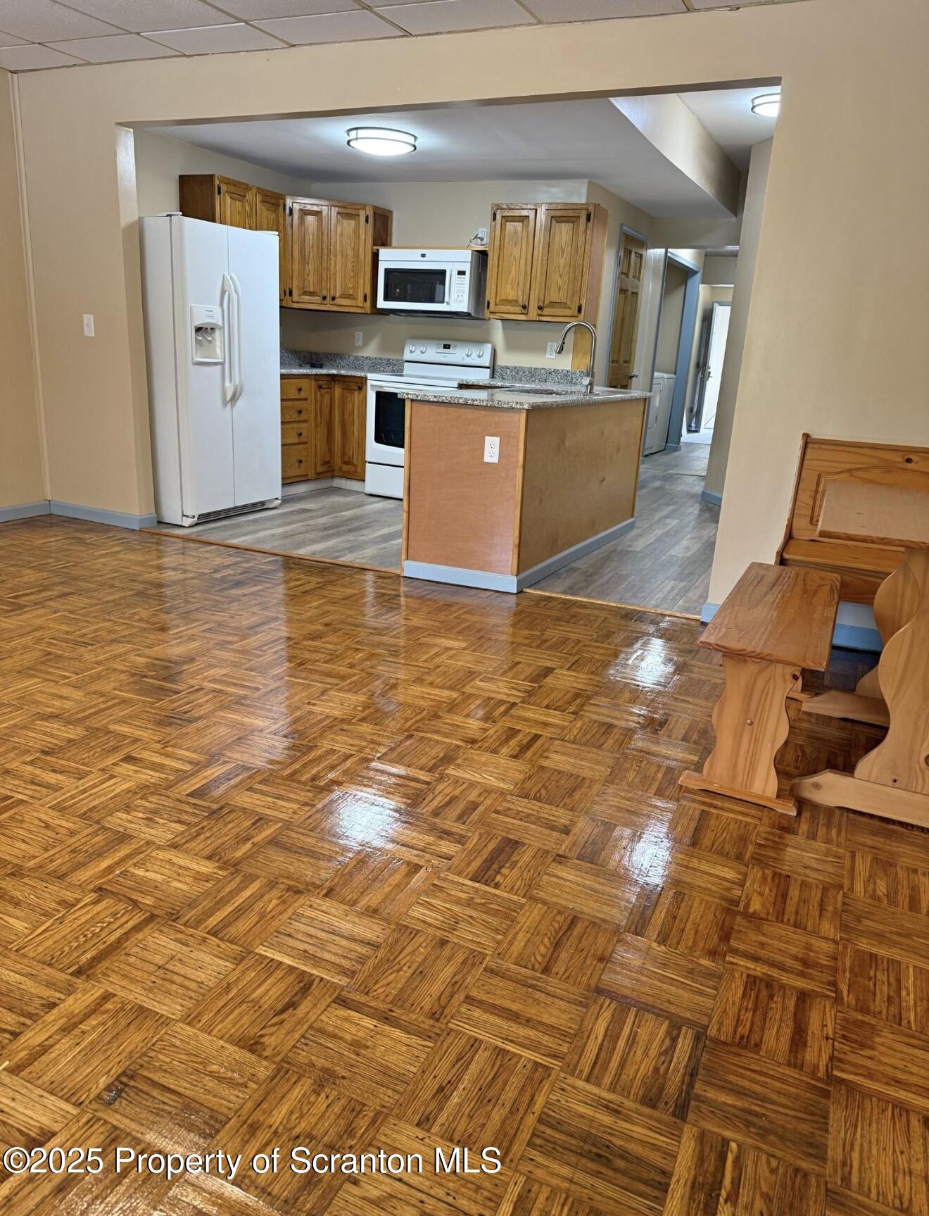 134 Market Street Moscow, PA 18444 - Photo 2 of 11 a view of a living room with kitchen countertops and wooden floor