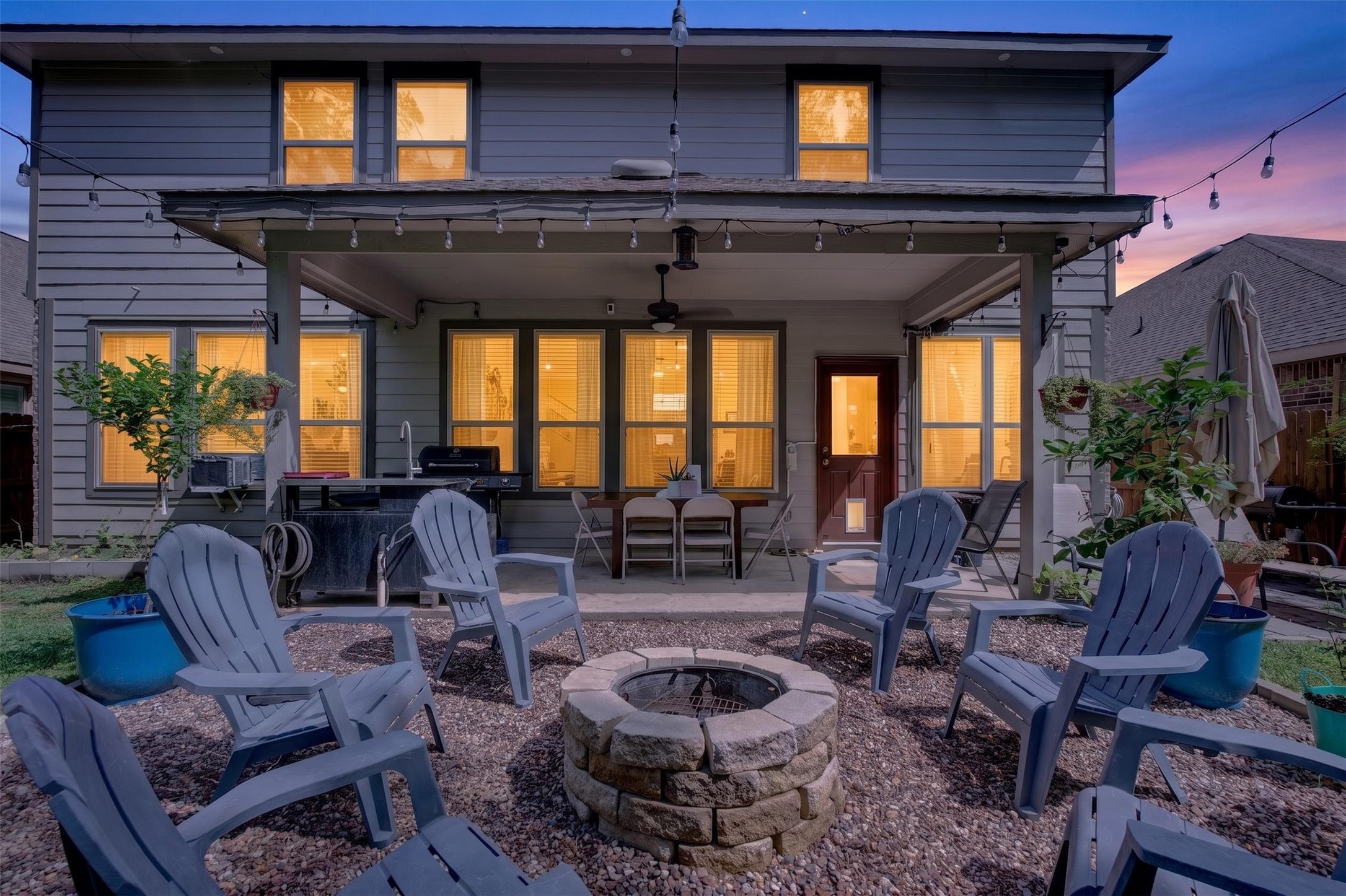 2832 Mistygate Court Conroe, TX 77301 - Photo 33 of 50 Stunning backyard retreat featuring a covered patio and cozy firepit, creating the perfect setting for relaxing evenings and outdoor gatherings.