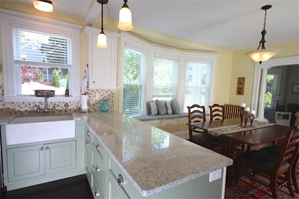 48 Banks Road Swampscott, MA 01907 - Photo 11 of 28 a kitchen with granite countertop a stove a sink a dining table and chairs