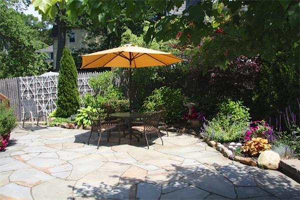 48 Banks Road Swampscott, MA 01907 - Photo 26 of 28 a view of a backyard with a table and chair under an umbrella