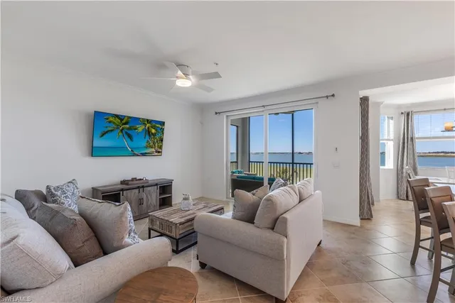 a living room with furniture a couch and a flat screen tv