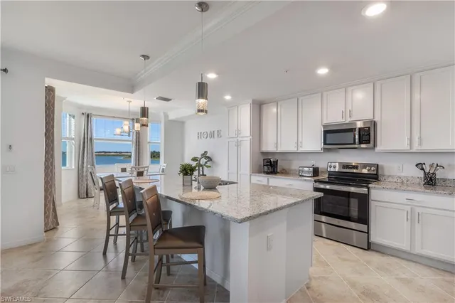 a kitchen with a sink stove cabinets and refrigerator
