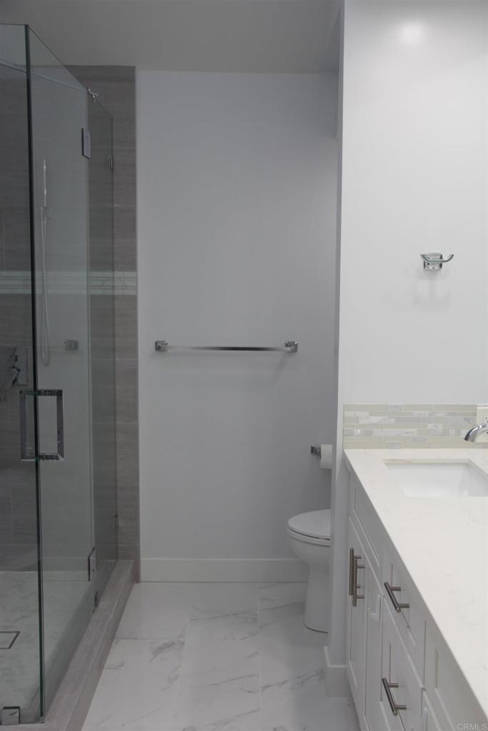 922 Sealane Drive, Unit B Encinitas, CA 92024 - Photo 16 of 30 a bathroom with a granite countertop sink toilet and shower