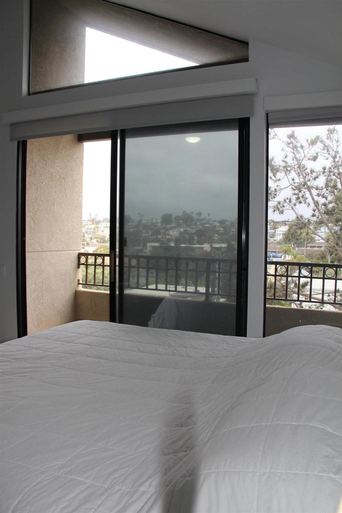 922 Sealane Drive, Unit B Encinitas, CA 92024 - Photo 18 of 30 a large bedroom with a large window and a balcony