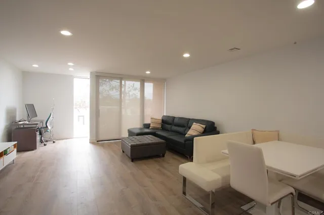 a living room with furniture and large windows