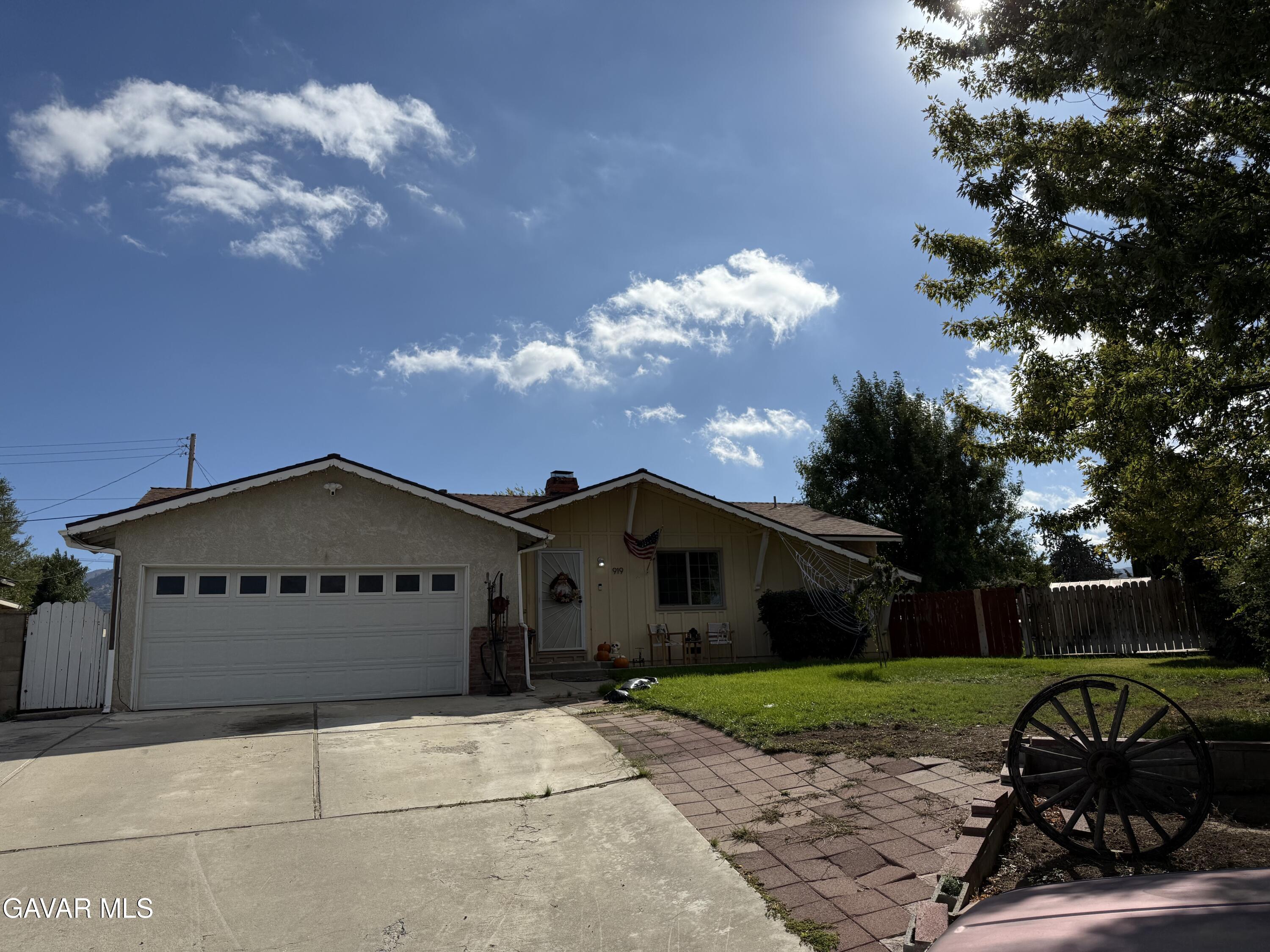 919 Golden W Court Tehachapi, CA 93561 - Photo 2 of 23 a front view of a house with a yard and garage