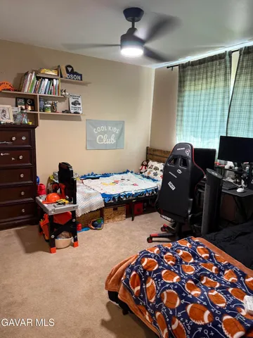 a bedroom with two beds and a window