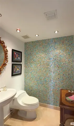 a bedroom with a bed and a flat tv screen on dresser