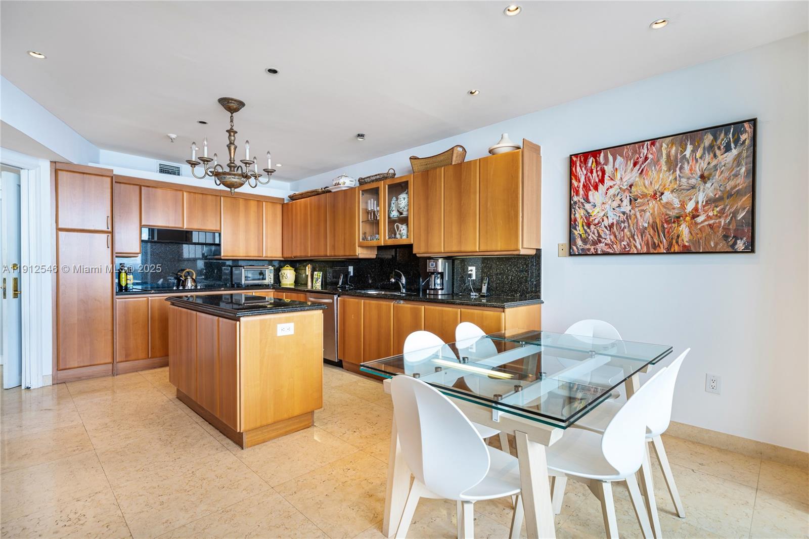 9559 Collins Avenue, Unit S7A Surfside, FL 33154 - Photo 36 of 43 a view of a dining room with furniture a kitchen and chandelier