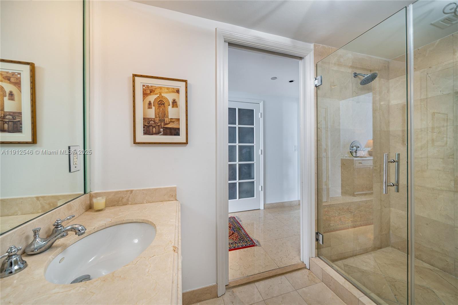 9559 Collins Avenue, Unit S7A Surfside, FL 33154 - Photo 38 of 43 a bathroom with a sink and a mirror