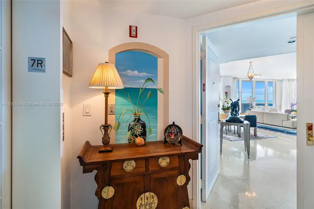 a living room with furniture a chandelier and a dining table