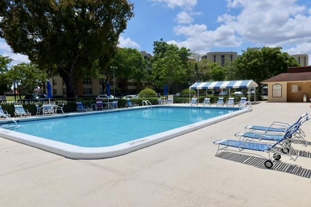 Inverrary Lauderhill, FL 33319 - Photo 12 of 15 a view of a swimming pool with a patio and a yard