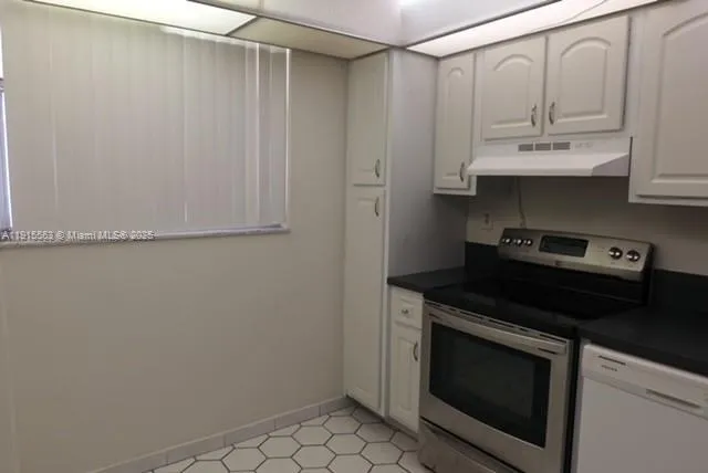 a stove top oven sitting inside of a kitchen