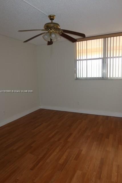 Inverrary Lauderhill, FL 33319 - Photo 6 of 15 an empty room with wooden floor fan and windows