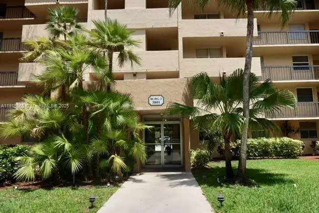 a view of a multi story building with a yard