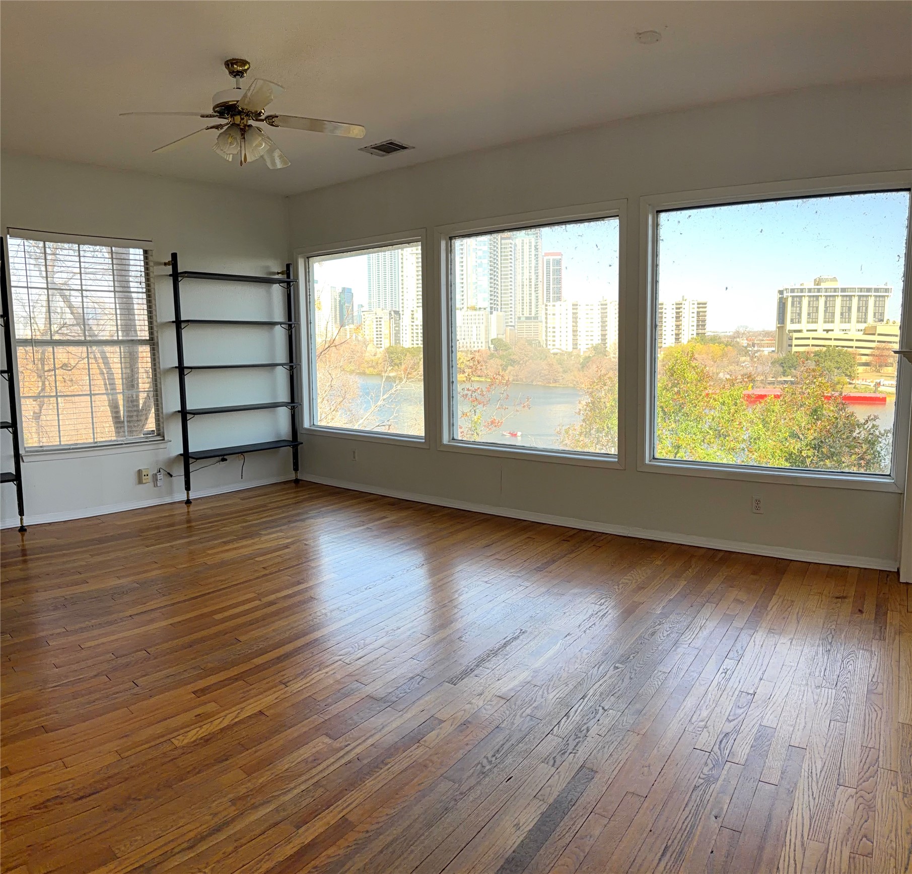 wooden floor in an empty room with a window
