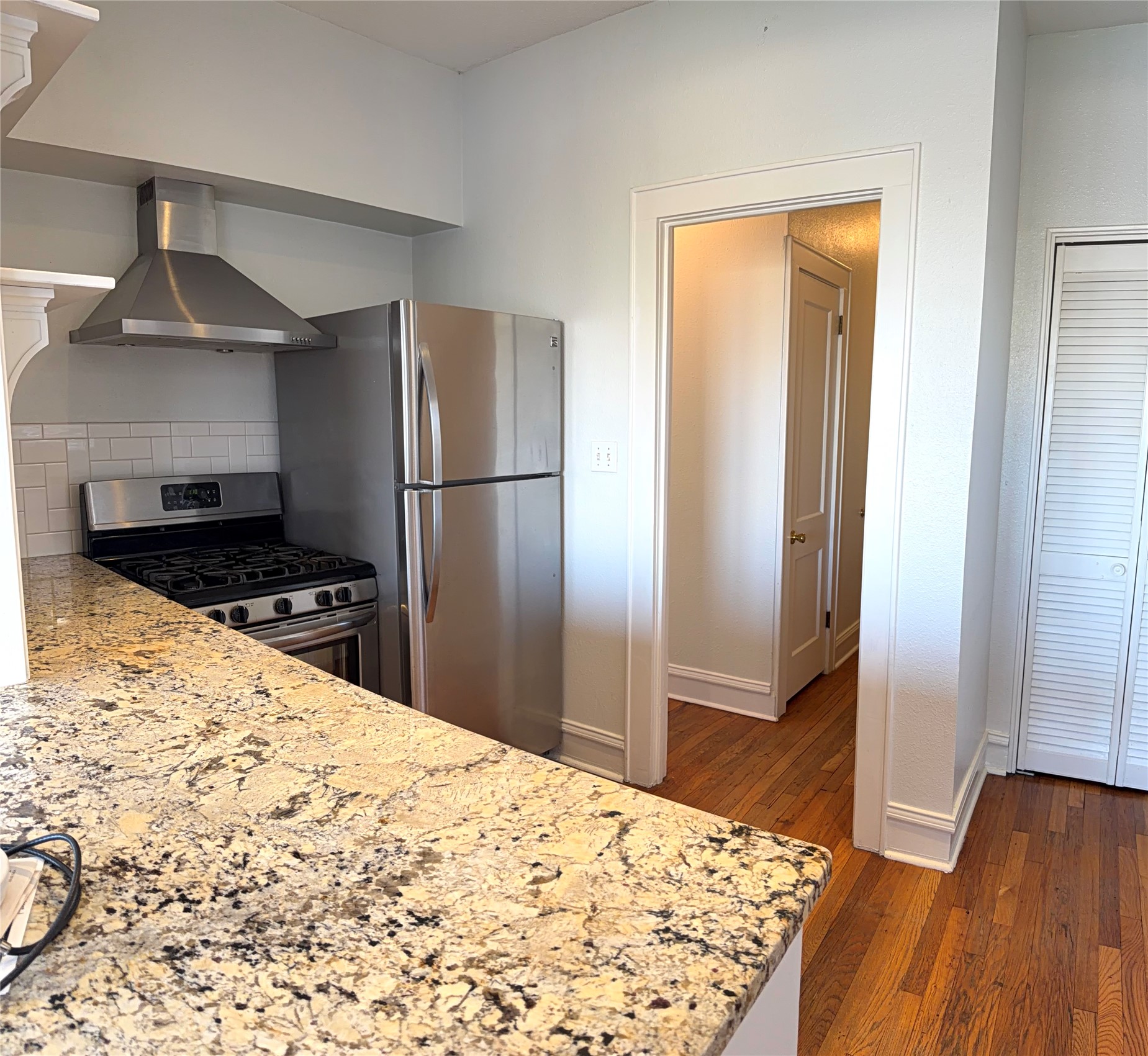 808 Edgecliff Terrace, Unit A Austin, TX 78704 - Photo 3 of 11 a kitchen with a refrigerator and a stove top oven