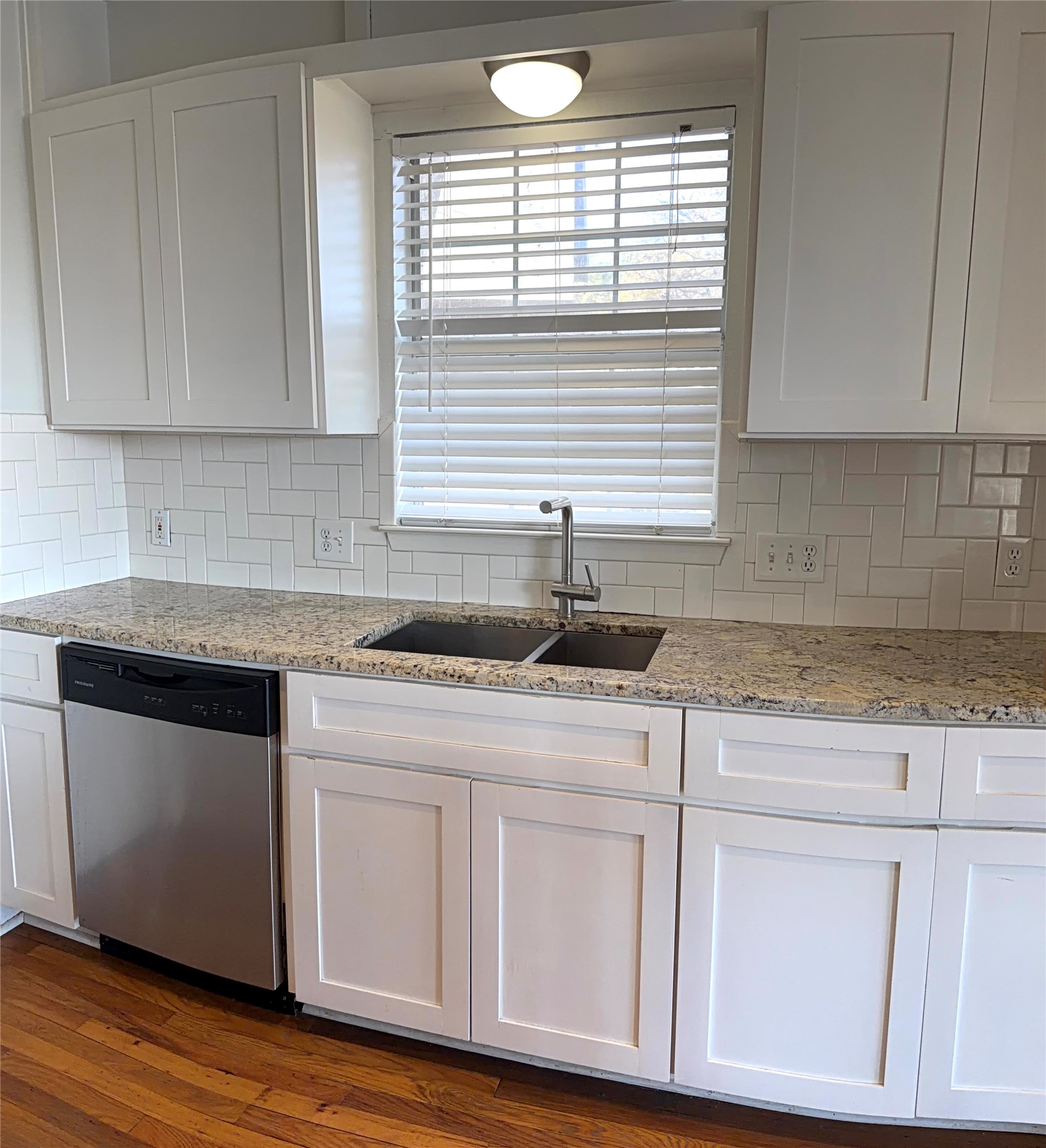 808 Edgecliff Terrace, Unit A Austin, TX 78704 - Photo 4 of 11 a kitchen with granite countertop white cabinets and a hard wood floor