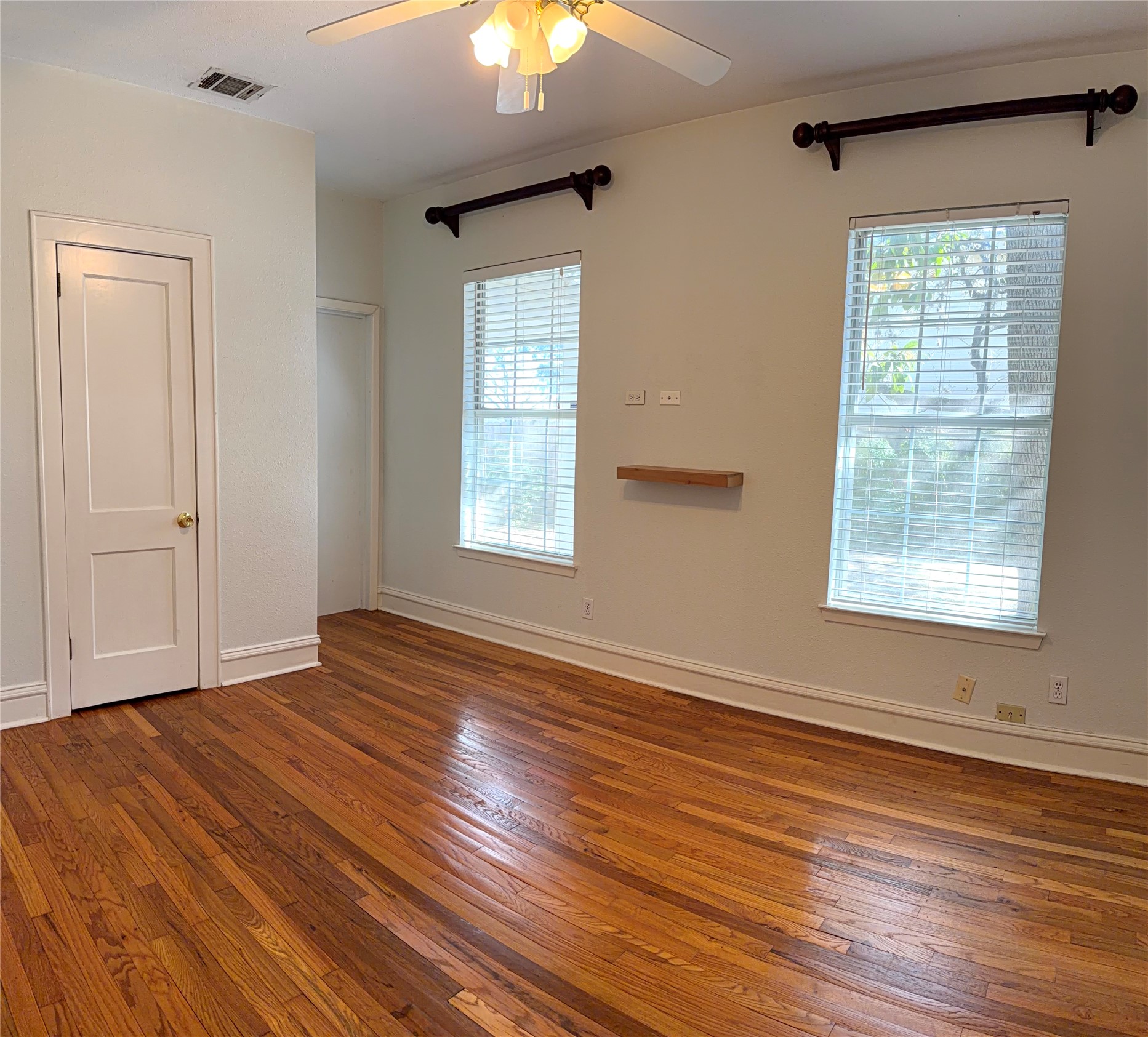 808 Edgecliff Terrace, Unit A Austin, TX 78704 - Photo 5 of 11 a view of an empty room with wooden floor and a window