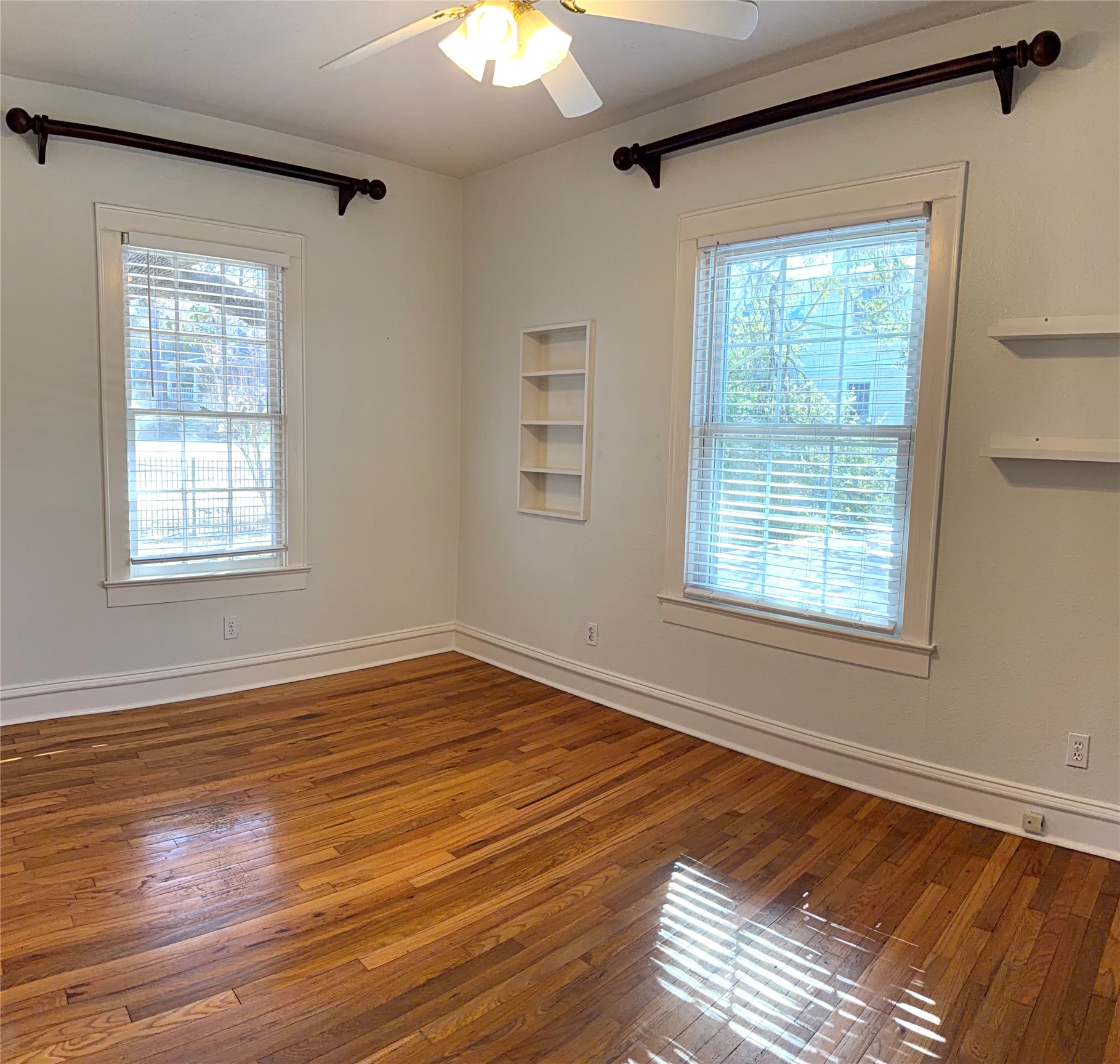 808 Edgecliff Terrace, Unit A Austin, TX 78704 - Photo 7 of 11 a view of an empty room with wooden floor and a window