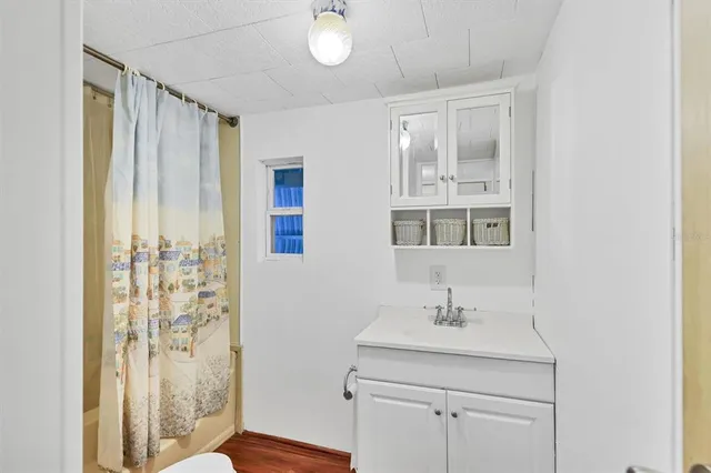 a bathroom with a sink a mirror and a shower