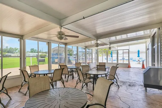 a view of a dining room with furniture large windows and wooden floor