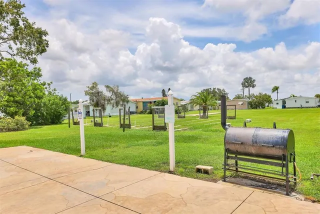 a view of a big building with a big yard and plants
