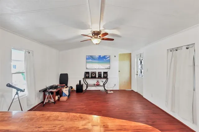 a view of a workspace with furniture and a chandelier fan