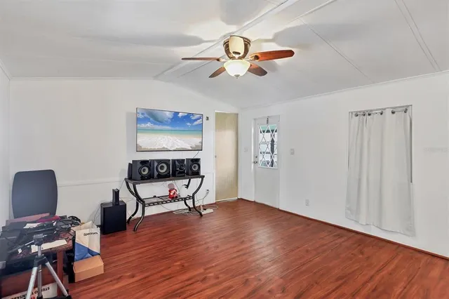 a view of a livingroom with hardwood floor and a ceiling fan