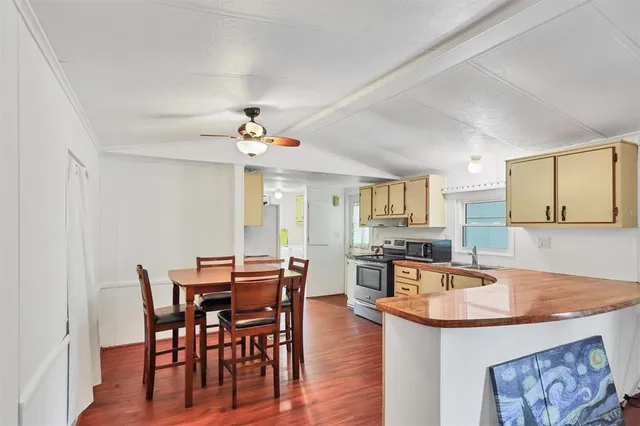 a view of a dining room with furniture and wooden floor