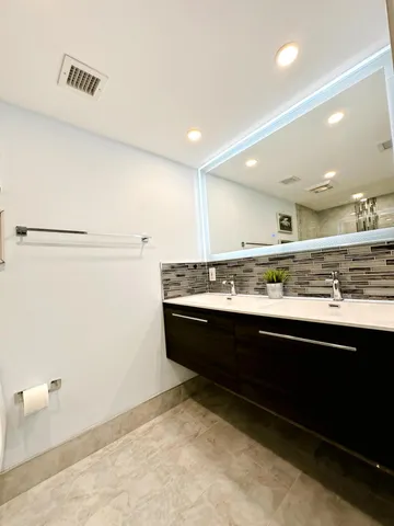 a view of kitchen with stainless steel appliances granite countertop cabinets and sink