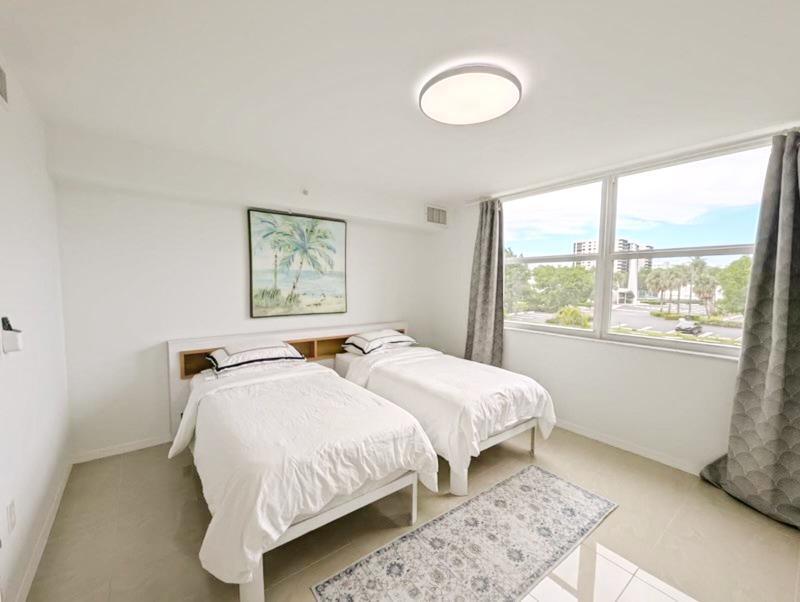 3594 South Ocean Boulevard, Unit 206 Highland Beach, FL 33487 - Photo 13 of 21 a bedroom with a bed and a window