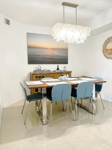 a kitchen with a dining table and chairs