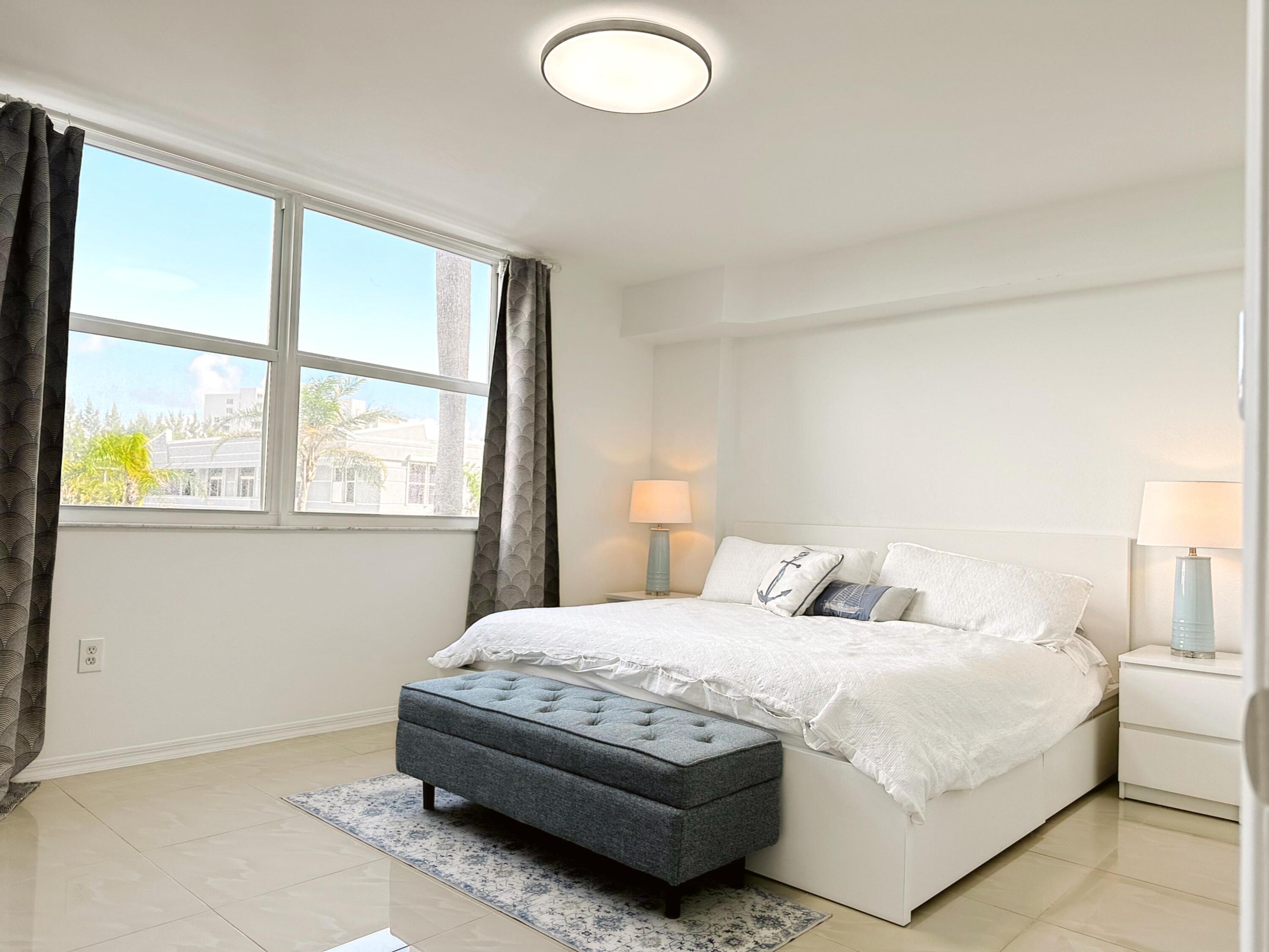 3594 South Ocean Boulevard, Unit 206 Highland Beach, FL 33487 - Photo 4 of 21 a bedroom with a bed and a large window