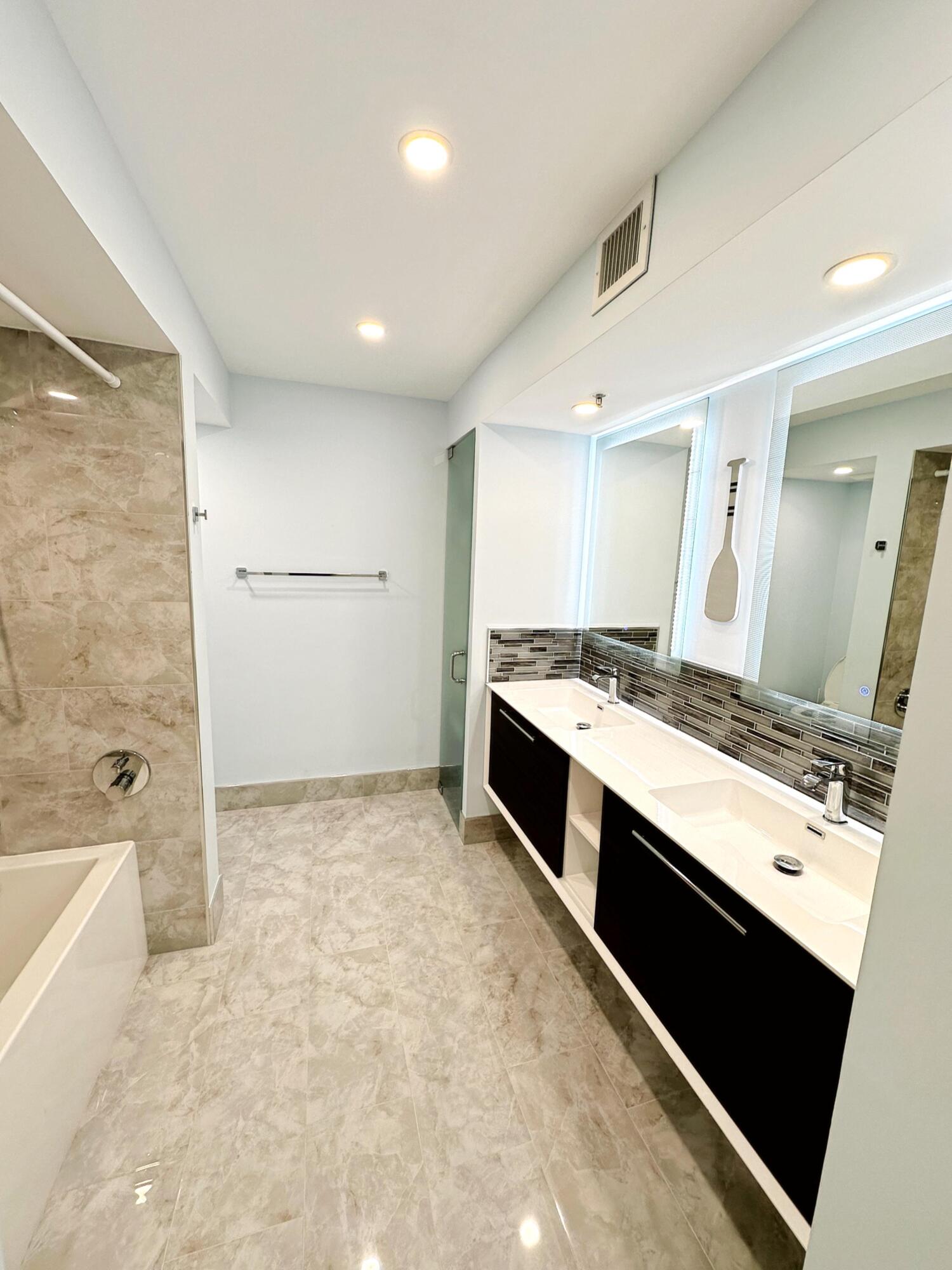 3594 South Ocean Boulevard, Unit 206 Highland Beach, FL 33487 - Photo 9 of 21 a large white kitchen with a stove a sink and a refrigerator