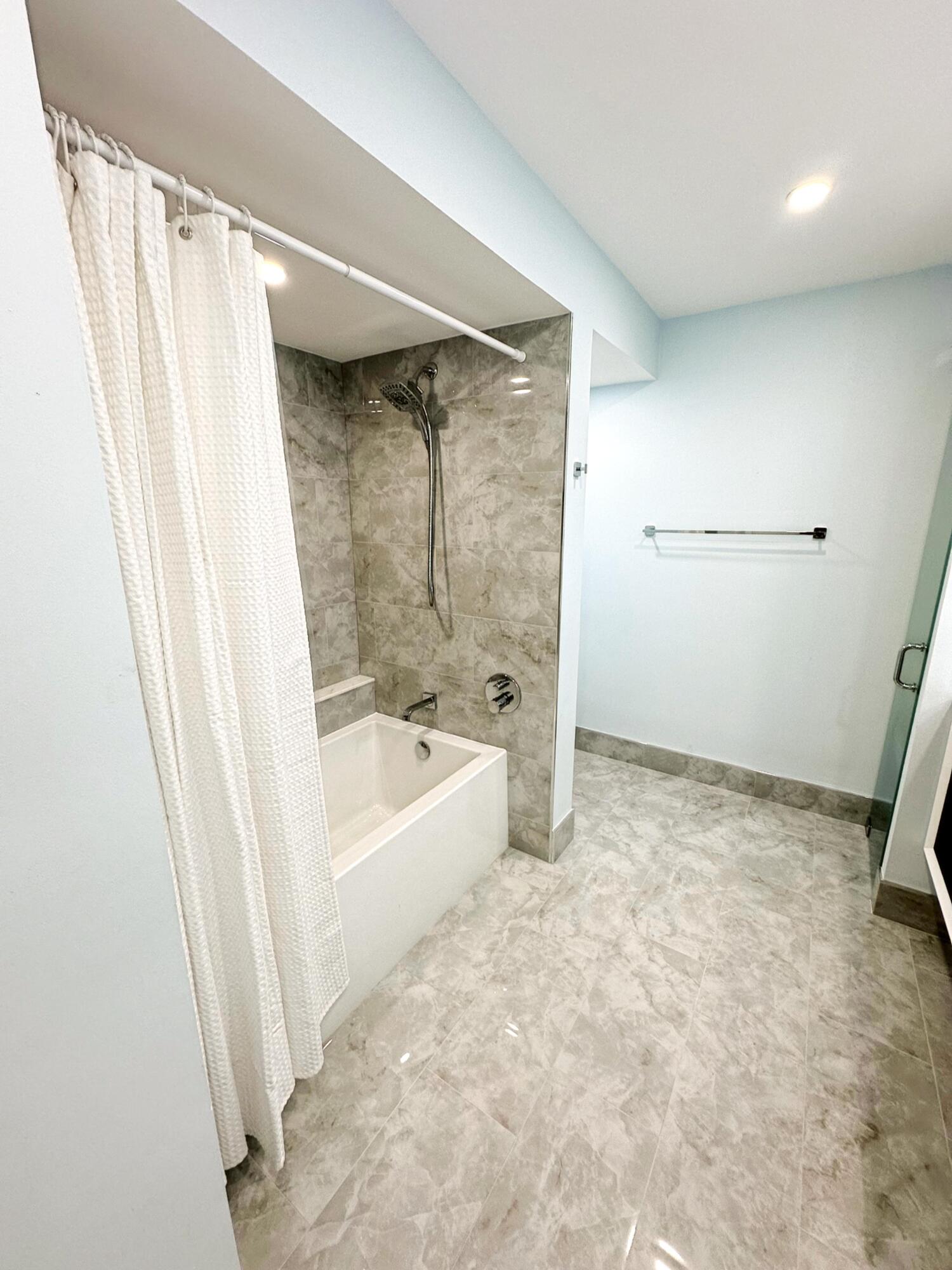 3594 South Ocean Boulevard, Unit 206 Highland Beach, FL 33487 - Photo 10 of 21 a bathroom with a bathtub and a shower