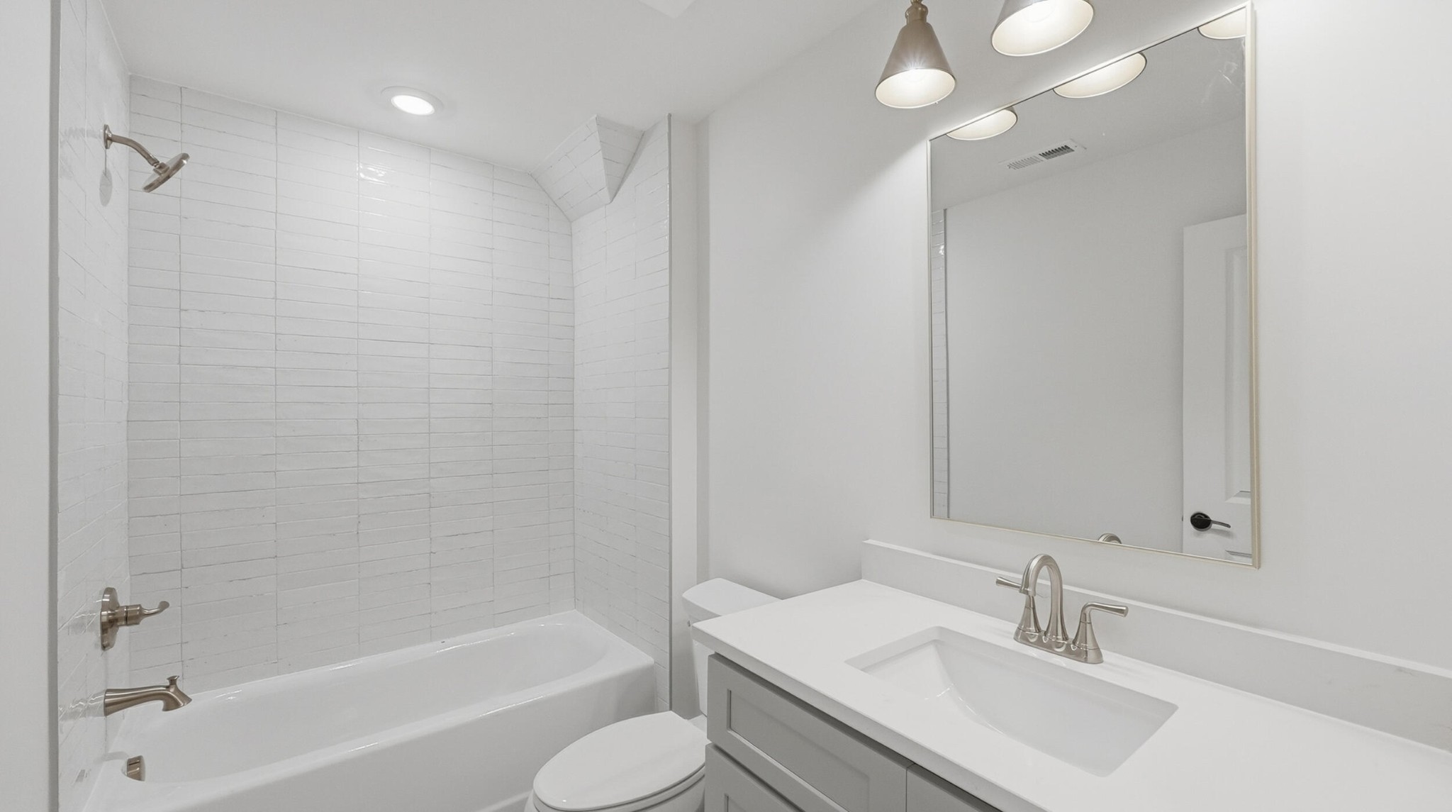 4692 Dempsey Way Chattanooga, TN 37419 - Photo 31 of 37 a bathroom with a bathtub a sink a toilet and a mirror