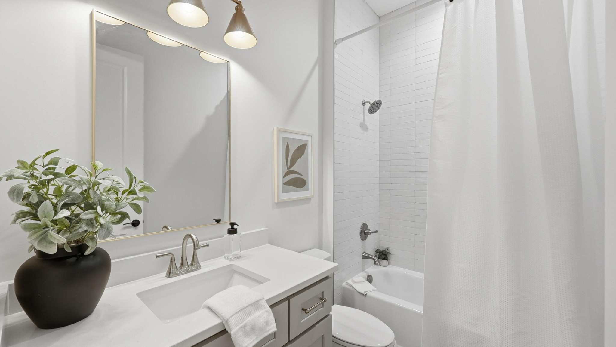 4692 Dempsey Way Chattanooga, TN 37419 - Photo 7 of 37 a bathroom with a sink a toilet and a mirror