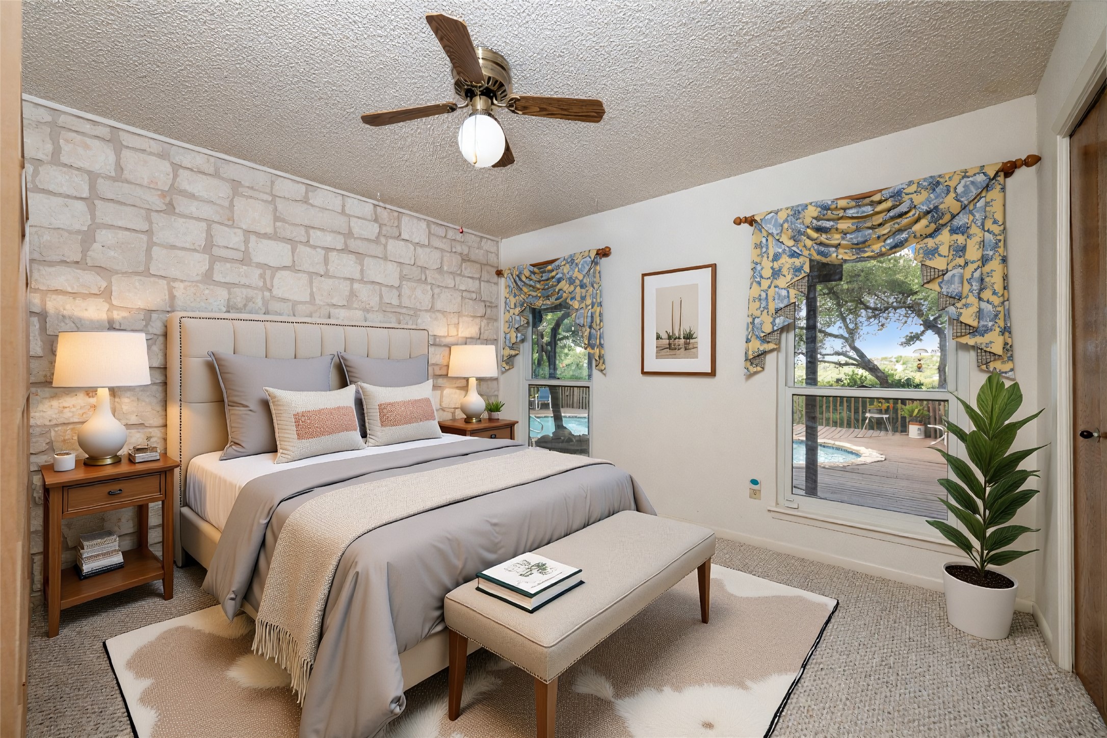 5319 Musket Ridge Austin, TX 78759 - Photo 27 of 39 A spacious bedroom retreat offers a unique stone accent wall and direct views of the inviting outdoor pool and decking.