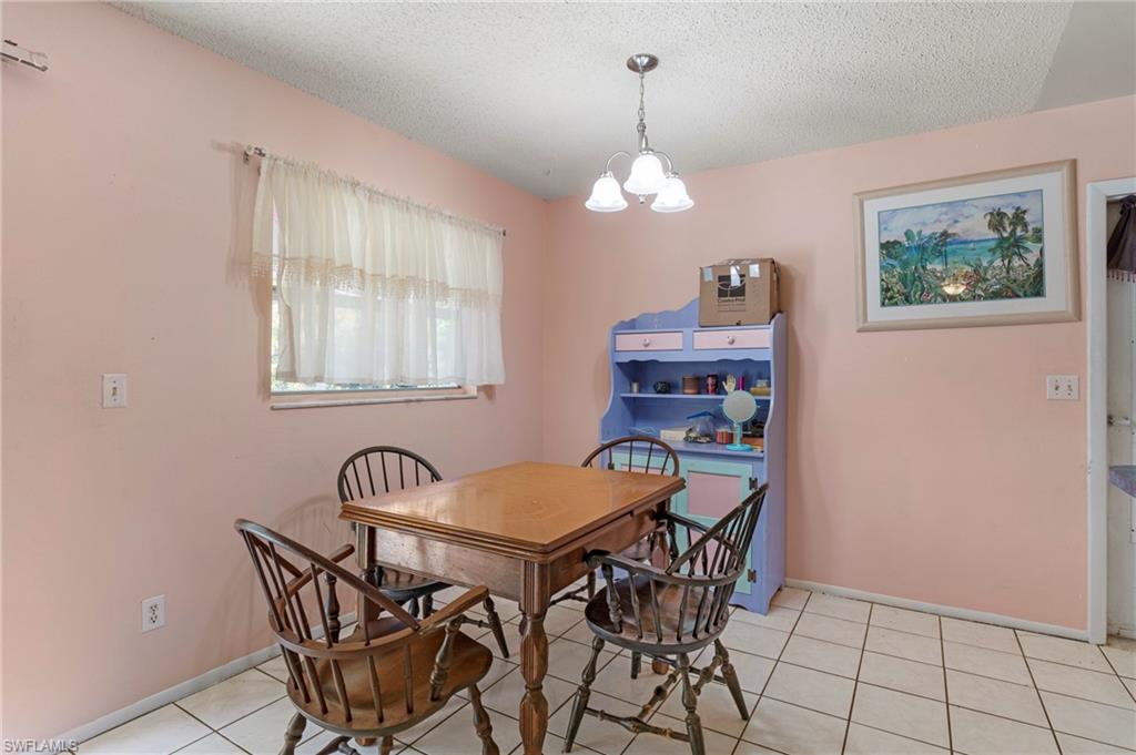 851 Barefoot Williams Road Naples, FL 34113 - Photo 11 of 35 a view of a dining room with furniture and chandelier