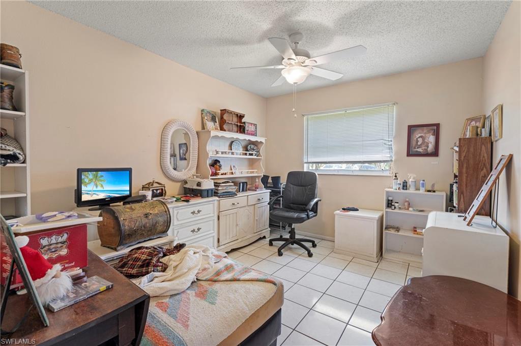 851 Barefoot Williams Road Naples, FL 34113 - Photo 14 of 35 a living room with furniture and a flat screen tv