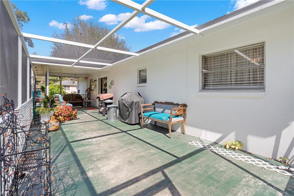 851 Barefoot Williams Road Naples, FL 34113 - Photo 21 of 35 a room with lots of furniture and a chandelier