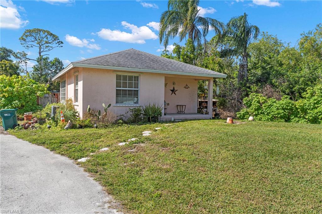 851 Barefoot Williams Road Naples, FL 34113 - Photo 24 of 35 a front view of house with yard and green space